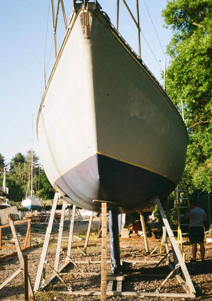 The hull is grey but there are patches of the white colour that can be seen through the grey paint. 