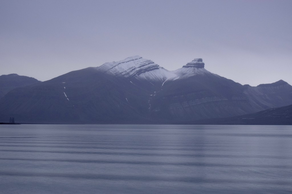 Snow capped mountains are seen in the distance. 