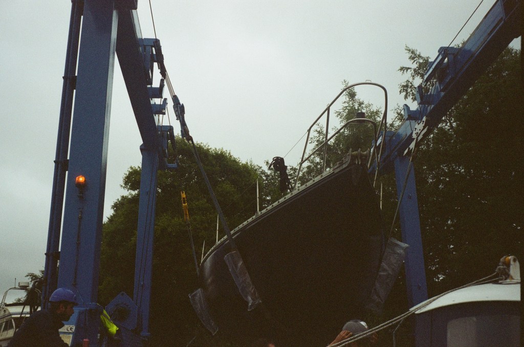A boat in a sling can be seen just after lifting. 