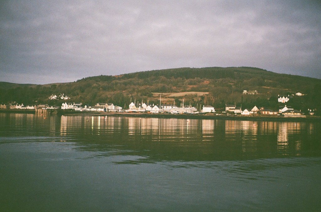 Lamlash seaside town is reflected in still waters. 